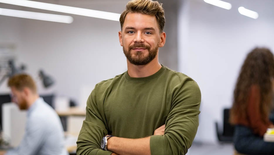 Successful mid business man looking at camera