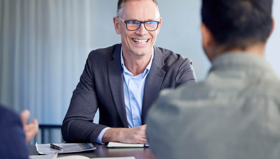 Devising big plans with the boss. Shot of two businessmen having